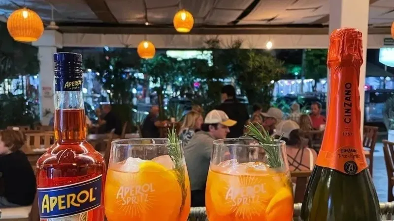 a bottle and a glass of orange juice