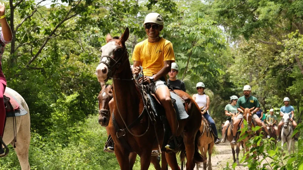 a group of people riding on the back of a horse
