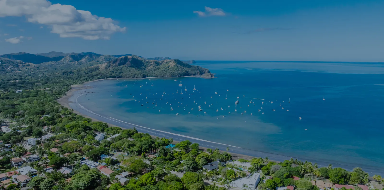 Aerial view of Guanacaste coastline with turquoise waters and tropical hills — Zindis Vacation Rentals