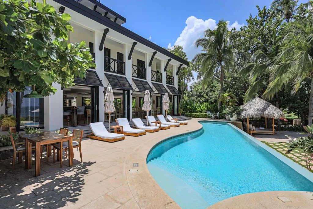 Modern Zindis vacation villa with pool, sun loungers, and tropical trees in Guanacaste, Costa Rica
